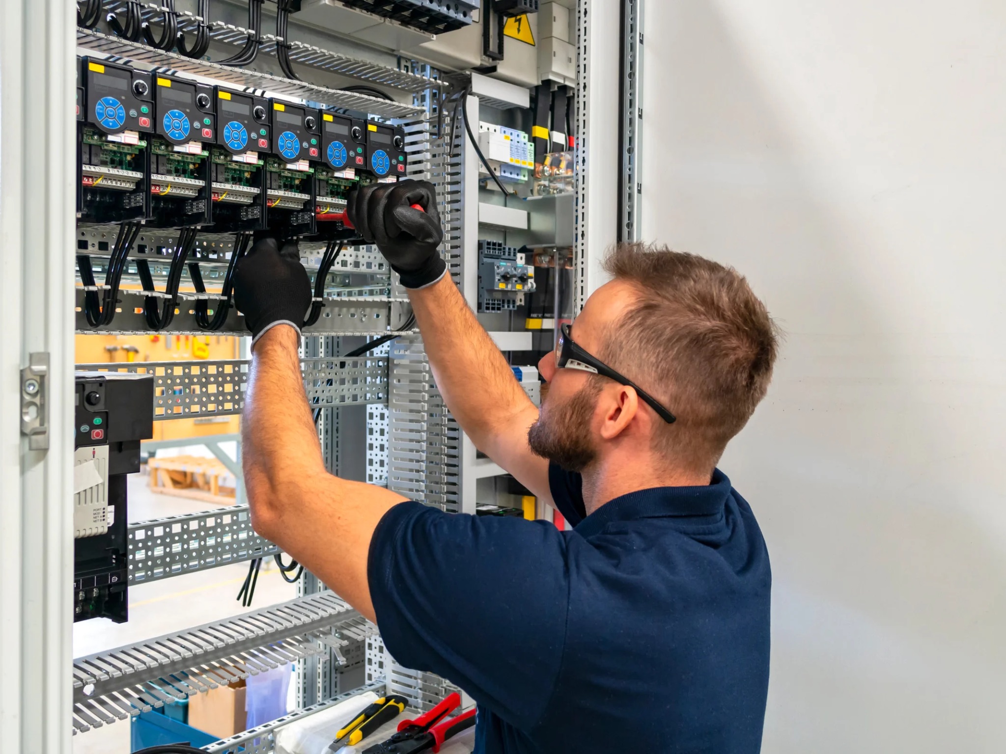 Licensed electrician working on residential switchboard in Elliott Heads